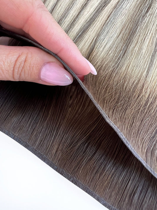 Close up on the innovative Volume Genius Weft extension binding. Showcasing the new weft does not have return hairs, giving maximum comfort. 