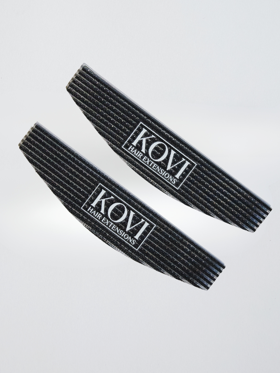  A pair of black KOVI curved hair grippers designed for secure hair sectioning during extension installations. The ergonomic curved shape provides better scalp contouring and grip, making the process smoother for professional stylists.