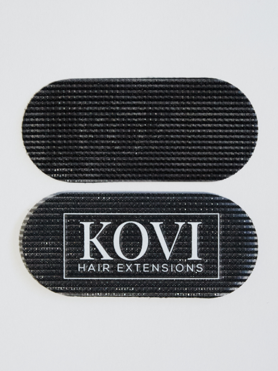 A close-up view of KOVI oval hair grippers designed for secure and discreet hair extension installations. These high-quality grippers provide a firm, comfortable hold for a flawless, natural blend, making them an essential tool for professional stylists and seamless hair transformation.