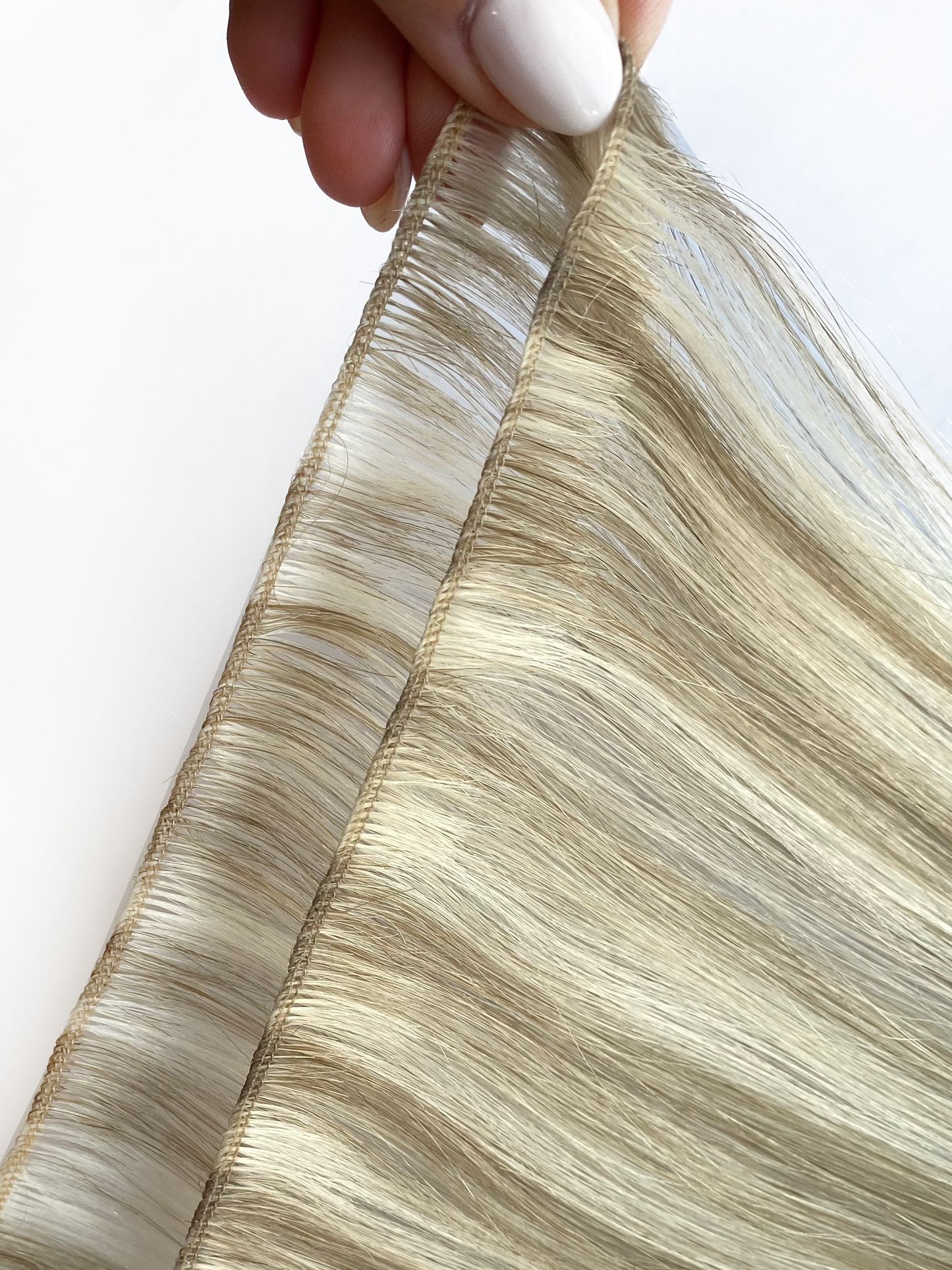 A open bundle of KOVI' remy human hair micro weft extensions.